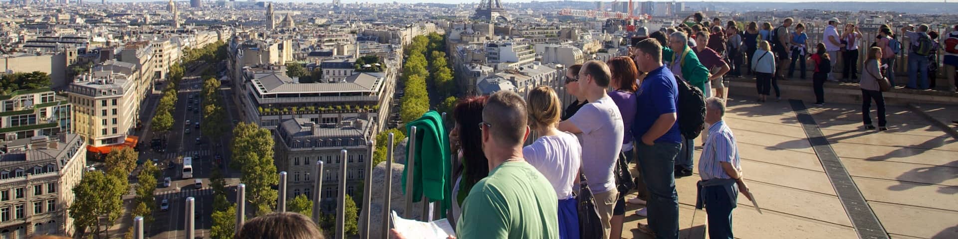 Stunning view from Arc de Triomphe showcasing the Paris skyline and Eiffel Tower with visitors enjoying the moment