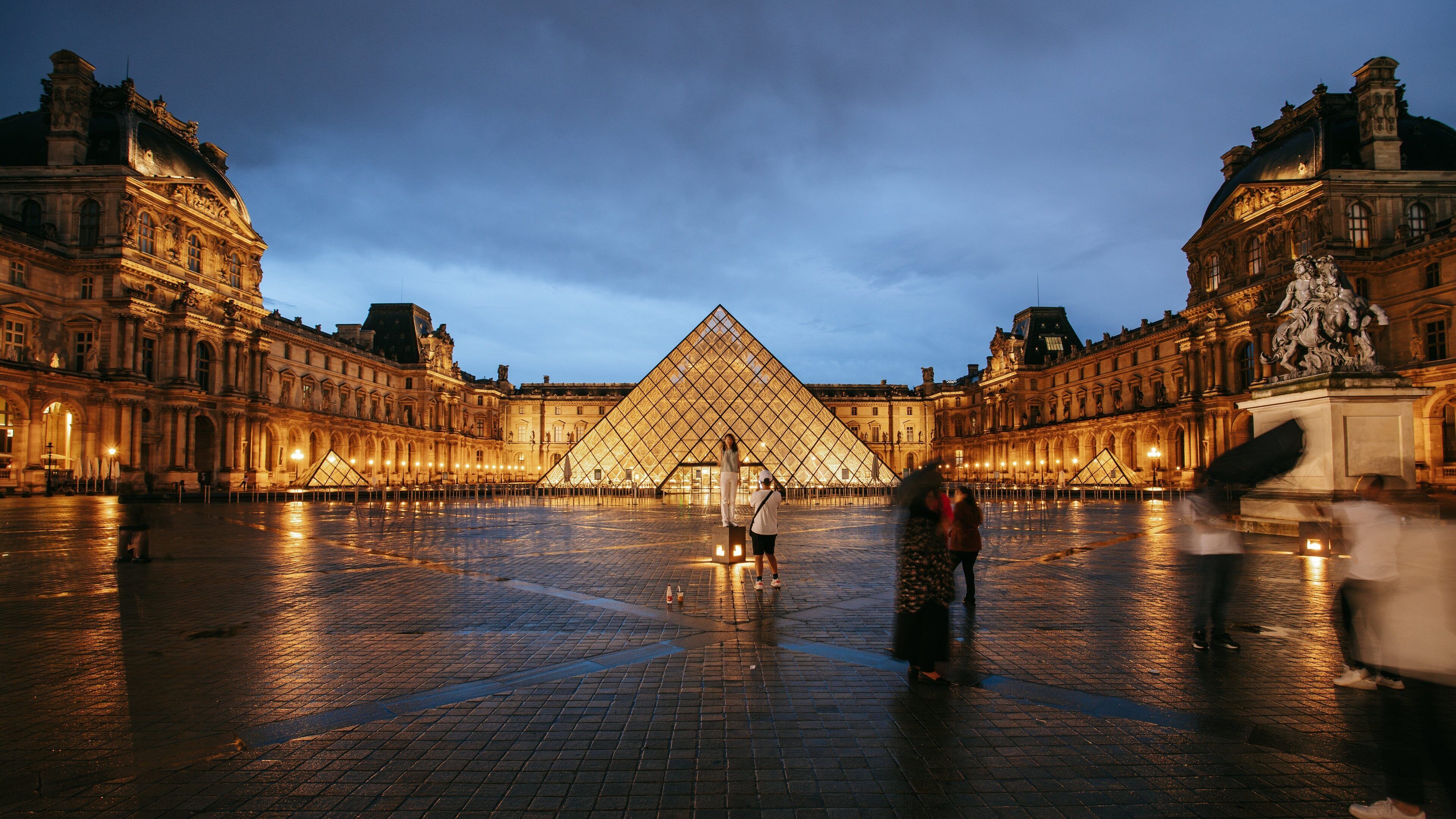 Louvre Museum which includes a square or plaza, a monument and night scenes
