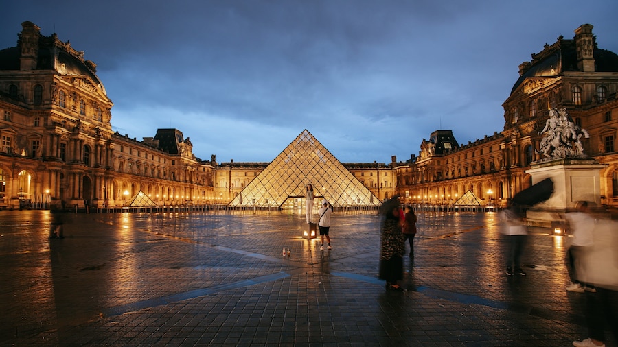 Louvre Museum which includes a square or plaza, a monument and night scenes