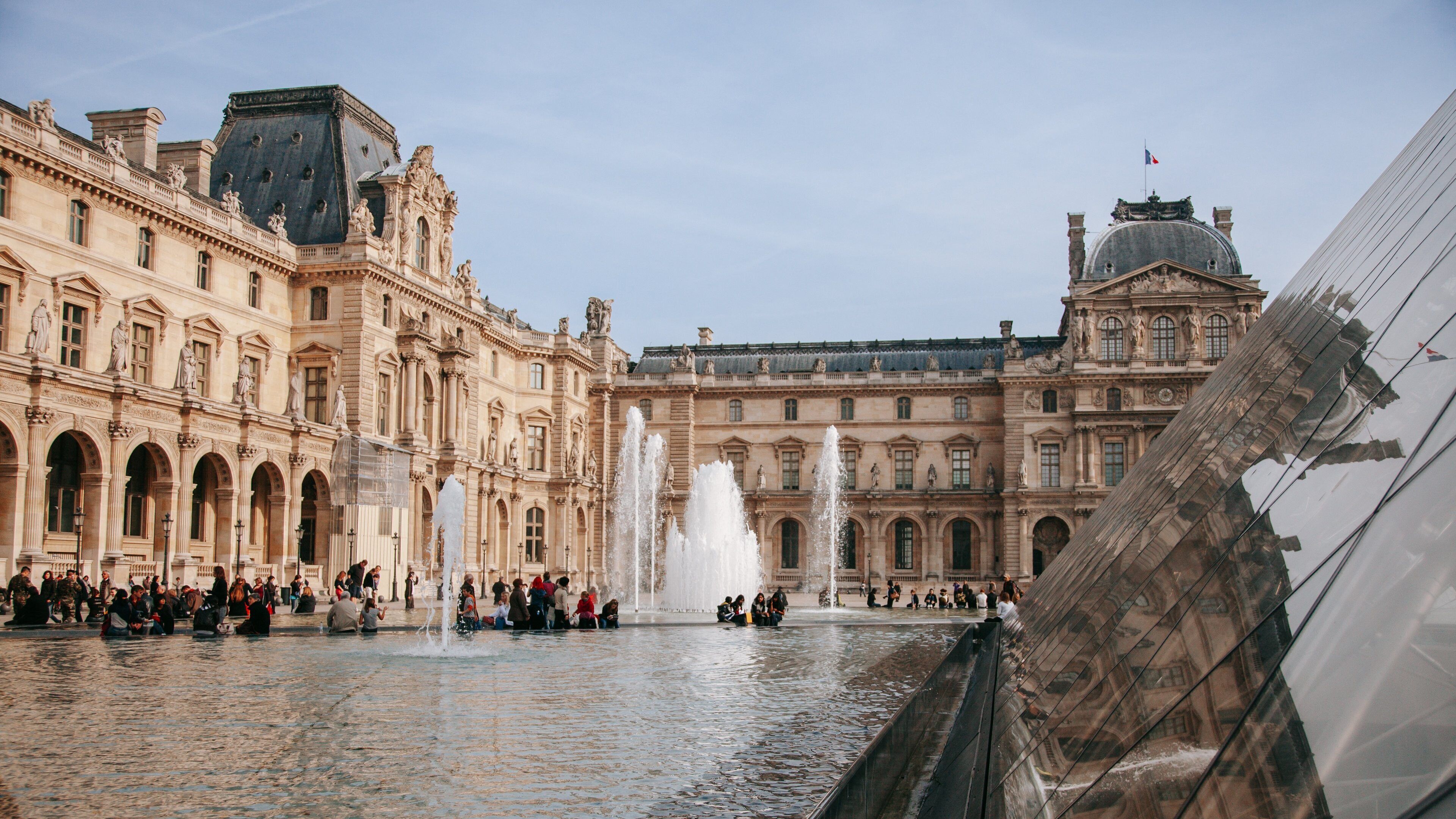 Louvre Museum featuring a fountain and heritage architecture