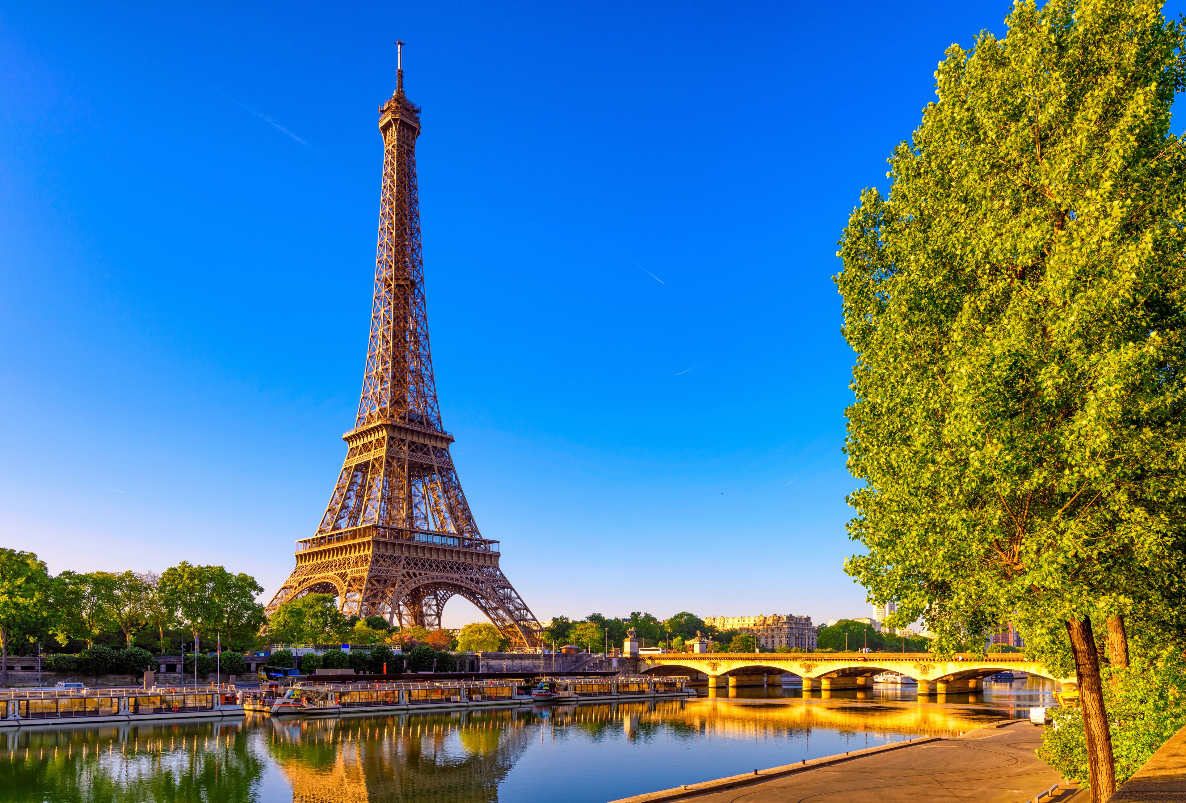 View of Eiffel Tower and river Seine at sunrise in Paris, France. Eiffel Tower is one of the most iconic landmarks of Paris