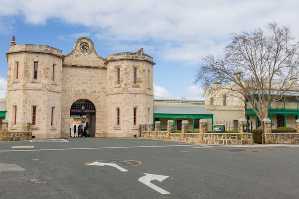 A historic stone building with a clock, a flag, and a sign reading "The Terrazzo".