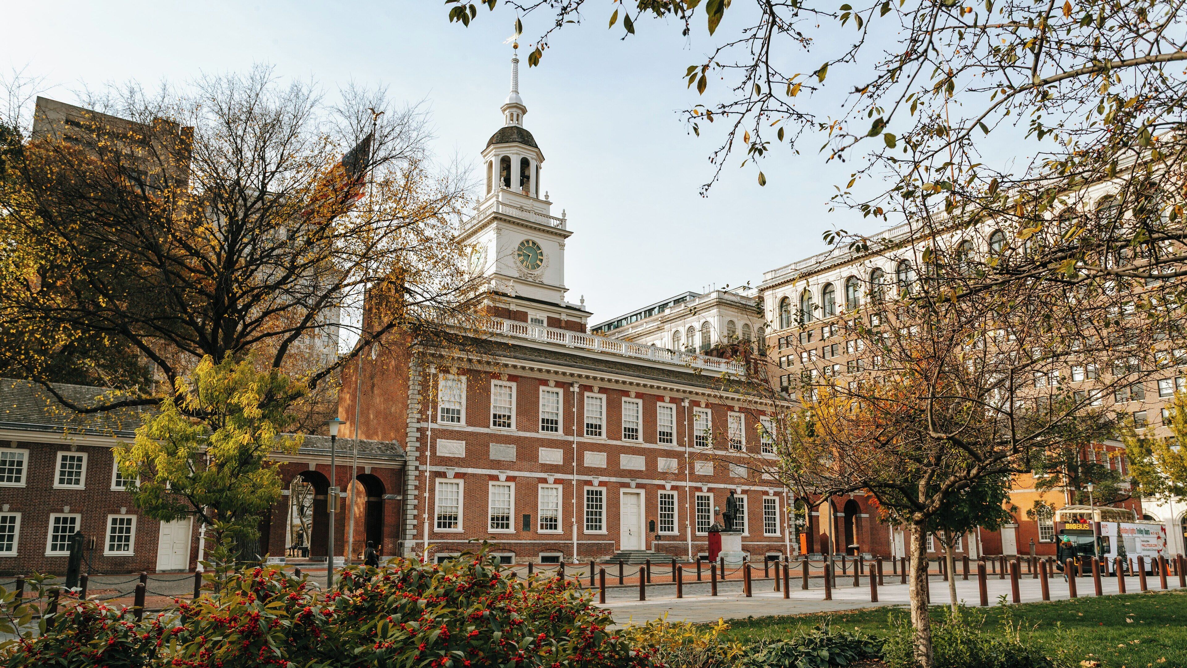 Historic Independence Hall stands amidst autumn foliage in Center City Philadelphia, showcasing its architectural beauty and important role in American history