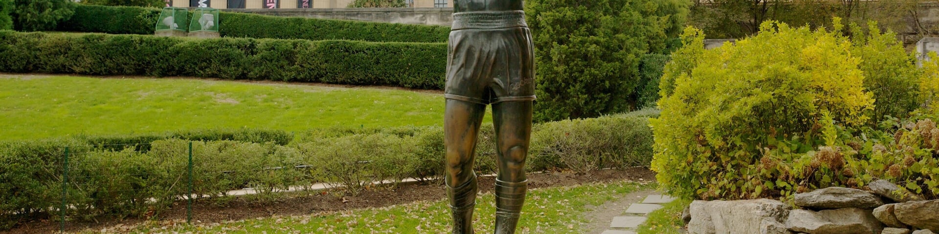 Iconic Rocky statue stands proudly outside the Philadelphia Museum of Art surrounded by lush greenery
