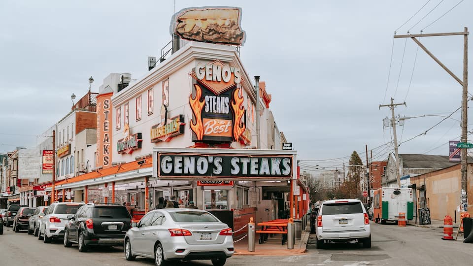 A building with a sign for Geno's Steaks.