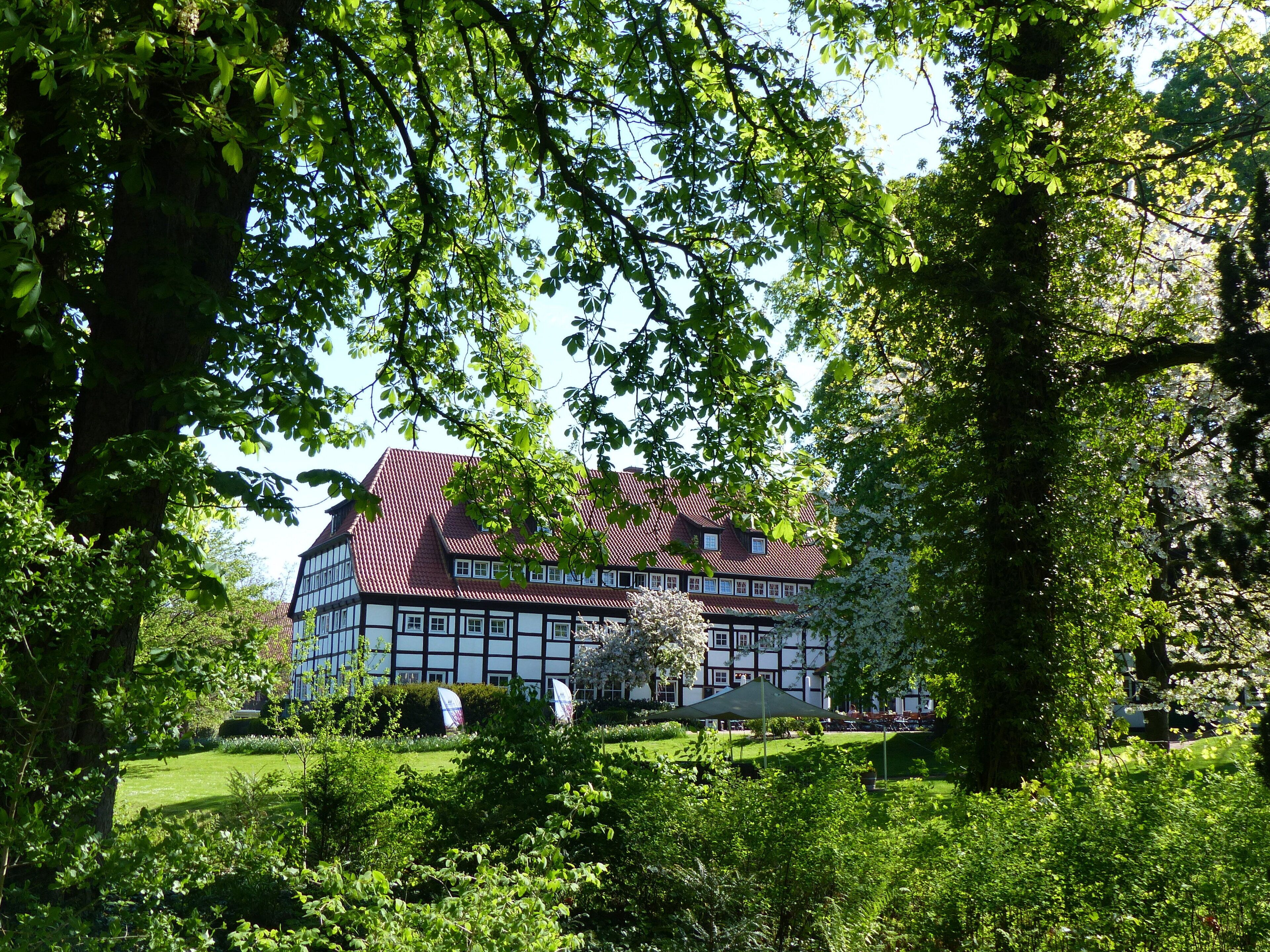 A traditional half-timbered house surrounded by lush greenery.