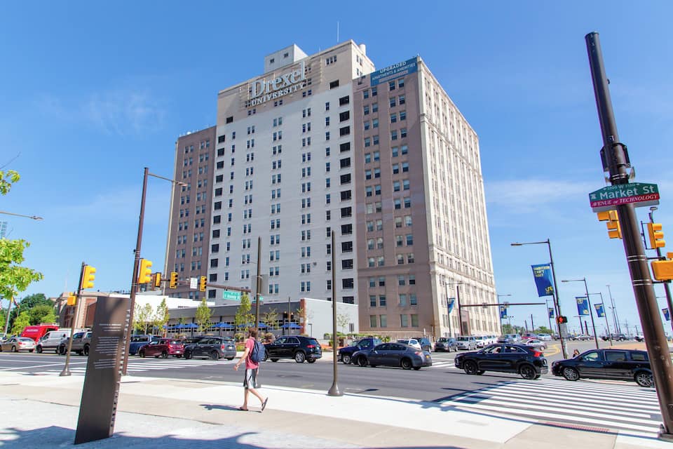 A Drexel University building, Market Street, and traffic lights.