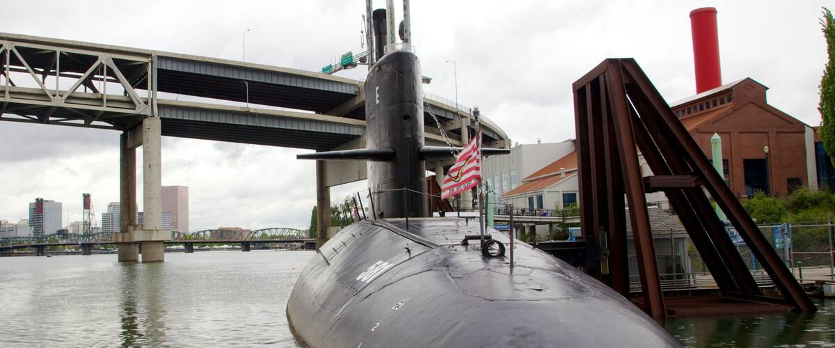 Oregon Museum of Science and Industry featuring a marina, skyline and military items