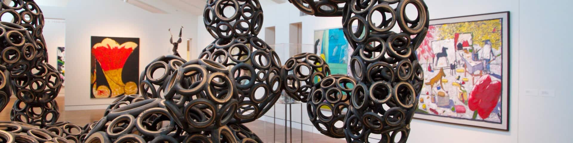 An art gallery with abstract sculptures and paintings.