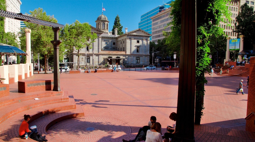 Pioneer Courthouse Square featuring street scenes and a square or plaza as well as a small group of people