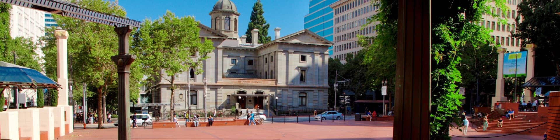 Pioneer Courthouse Square featuring street scenes and a square or plaza as well as a small group of people