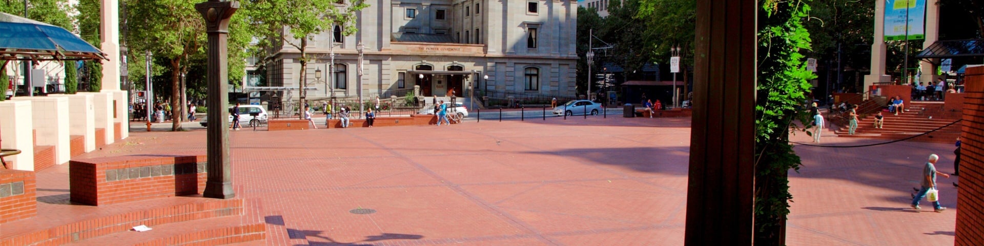 Pioneer Courthouse Square featuring street scenes and a square or plaza as well as a small group of people