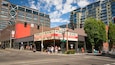 A bookstore named Powell's Books with a red and white sign, located at a street corner with modern buildings in the background.
