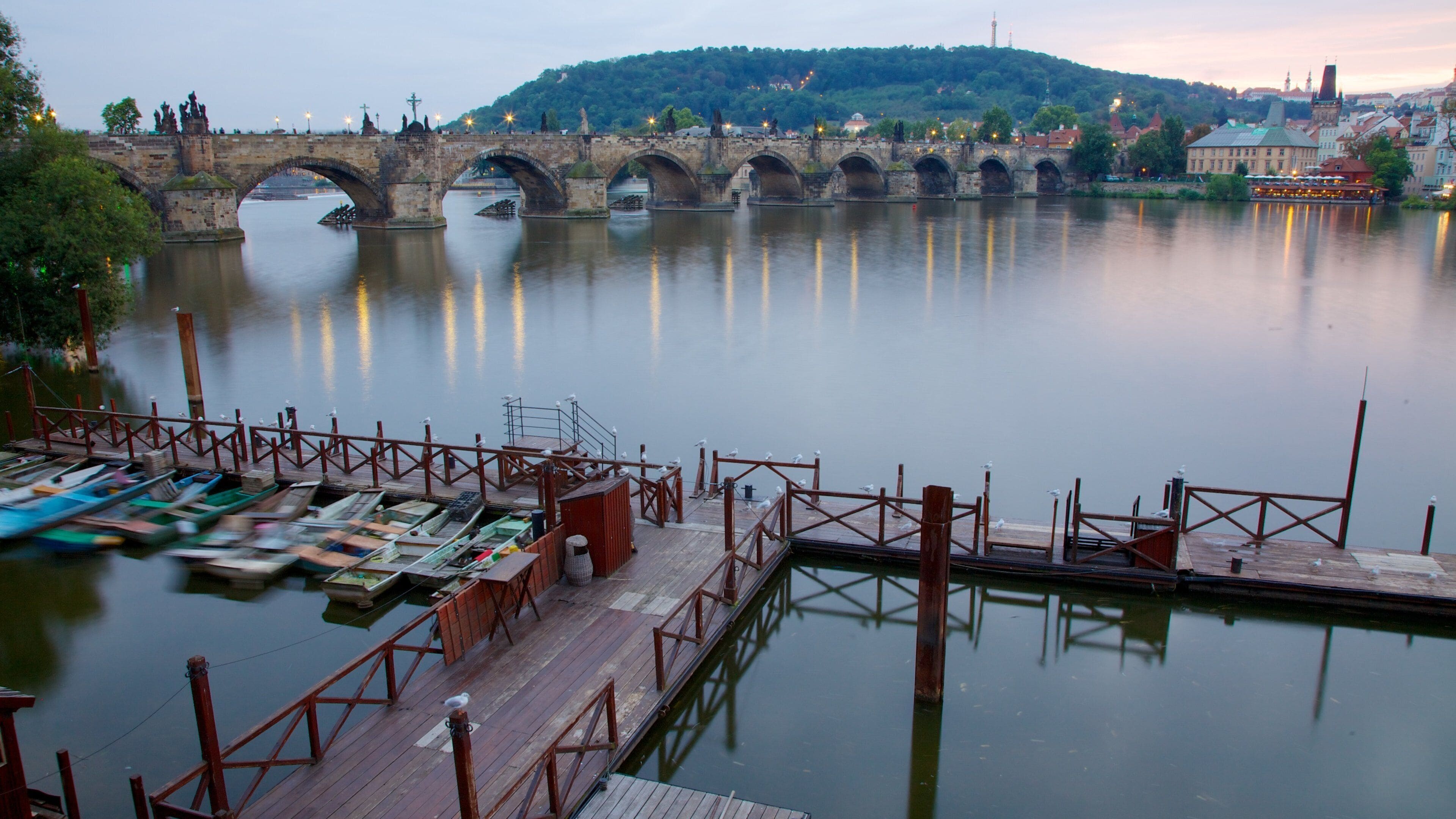 Prague Castle which includes a marina, a bridge and a river or creek