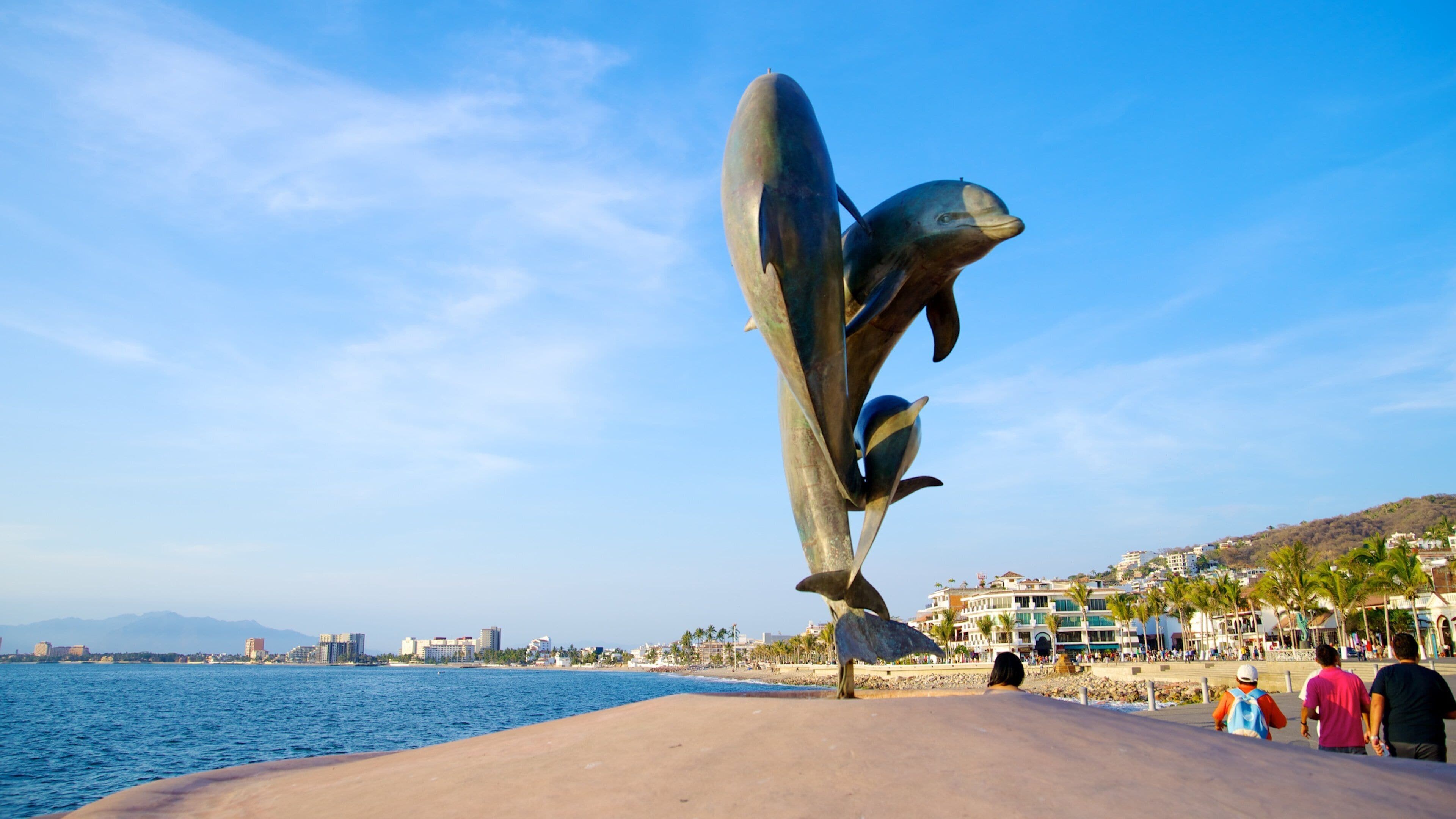 Malecon showing a coastal town, general coastal views and a statue or sculpture