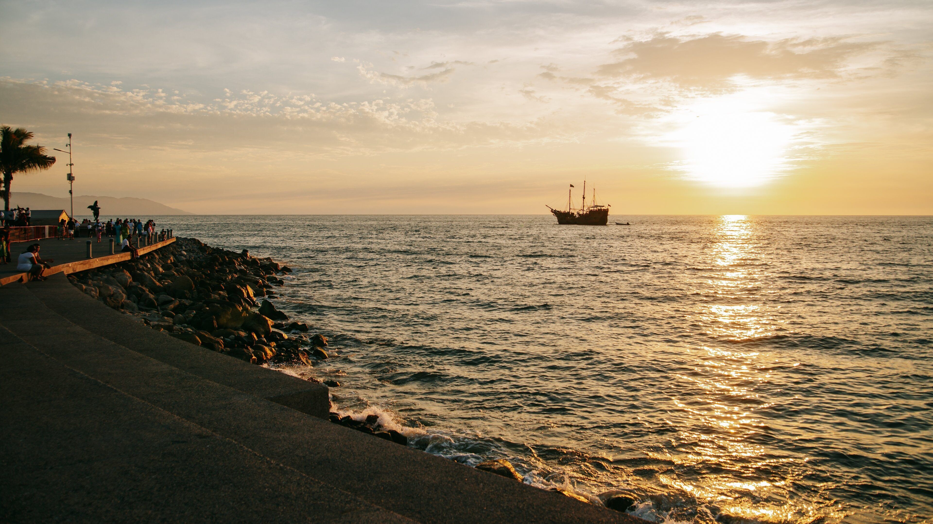Malecon which includes a sunset and general coastal views