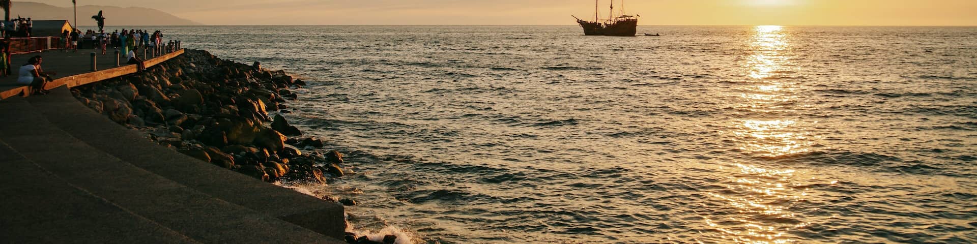 Malecon which includes a sunset and general coastal views