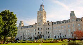 Parliament Building which includes heritage architecture, a garden and a sunset