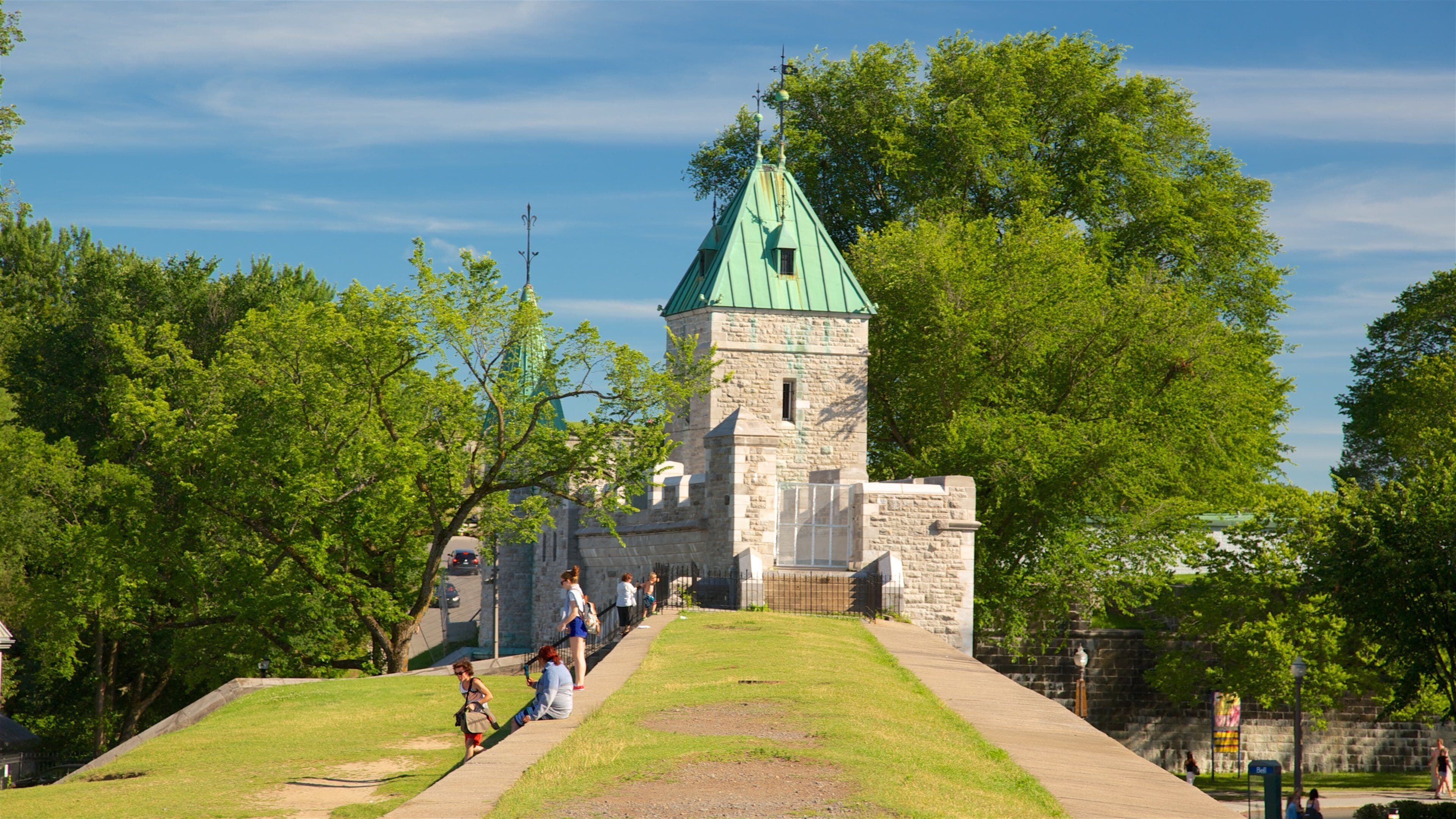 Parliament Building which includes a park and heritage elements as well as a small group of people
