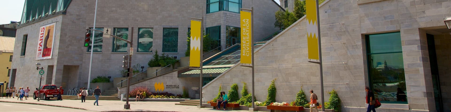 A modern building with a prominent tower and large windows. There are banners and signs indicating it is the Musée de la civilisation.