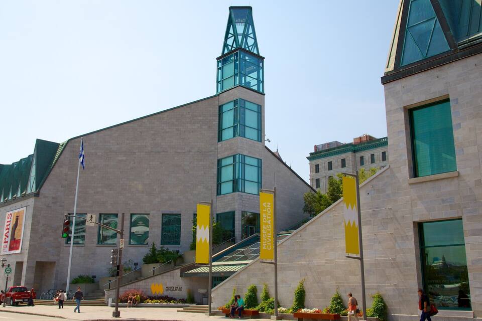 A modern building with a prominent tower and large windows. There are banners and signs indicating it is the Musée de la civilisation.