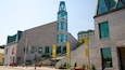A modern building with a prominent tower and large windows. There are banners and signs indicating it is the Musée de la civilisation.