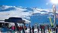 A snowy ski slope with a lift station, skiers, and a building labeled "CORONET EXPRESS".