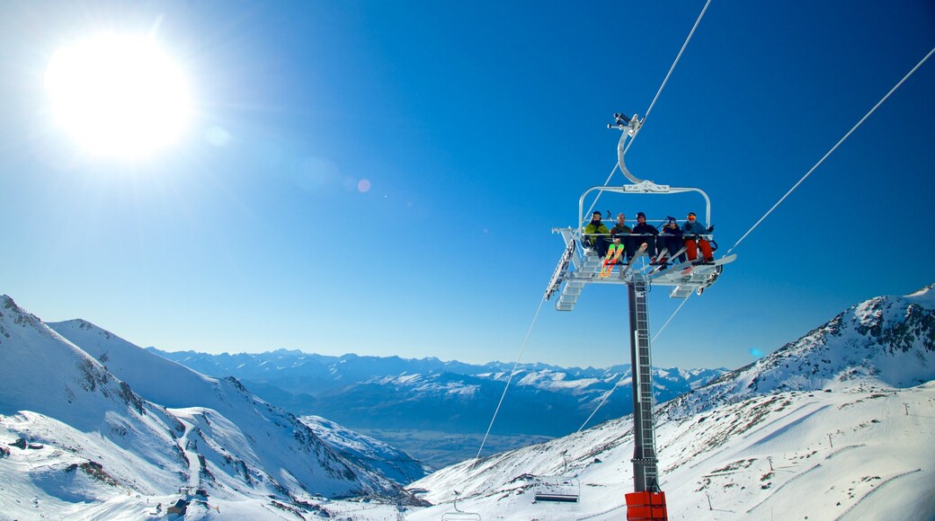 The Remarkables Ski Area showing a gondola and snow as well as a small group of people