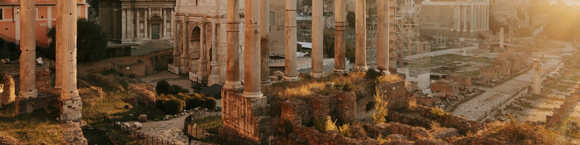 Roman Forum which includes a ruin, heritage elements and a sunset