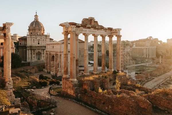 Roman Forum which includes a ruin, heritage elements and a sunset