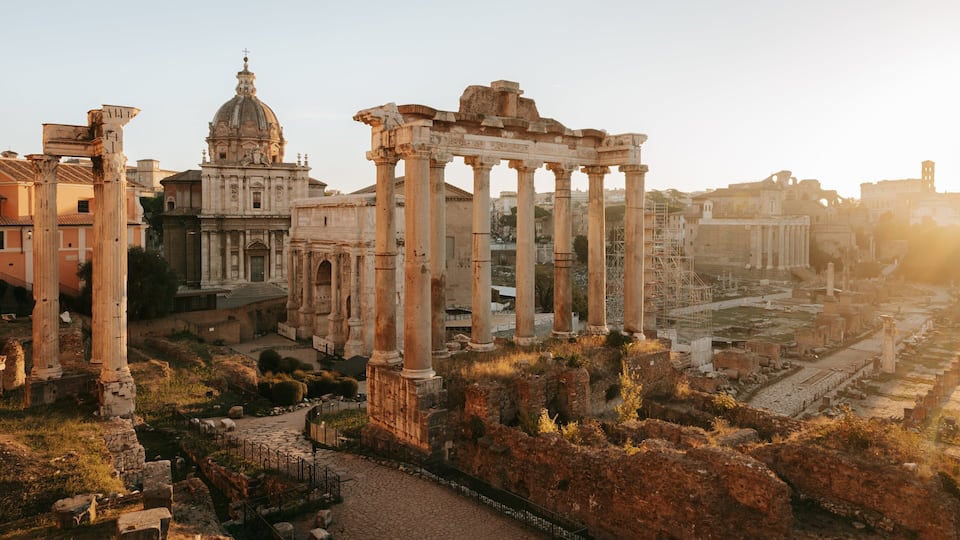 Ancient ruins with columns and a large dome structure.