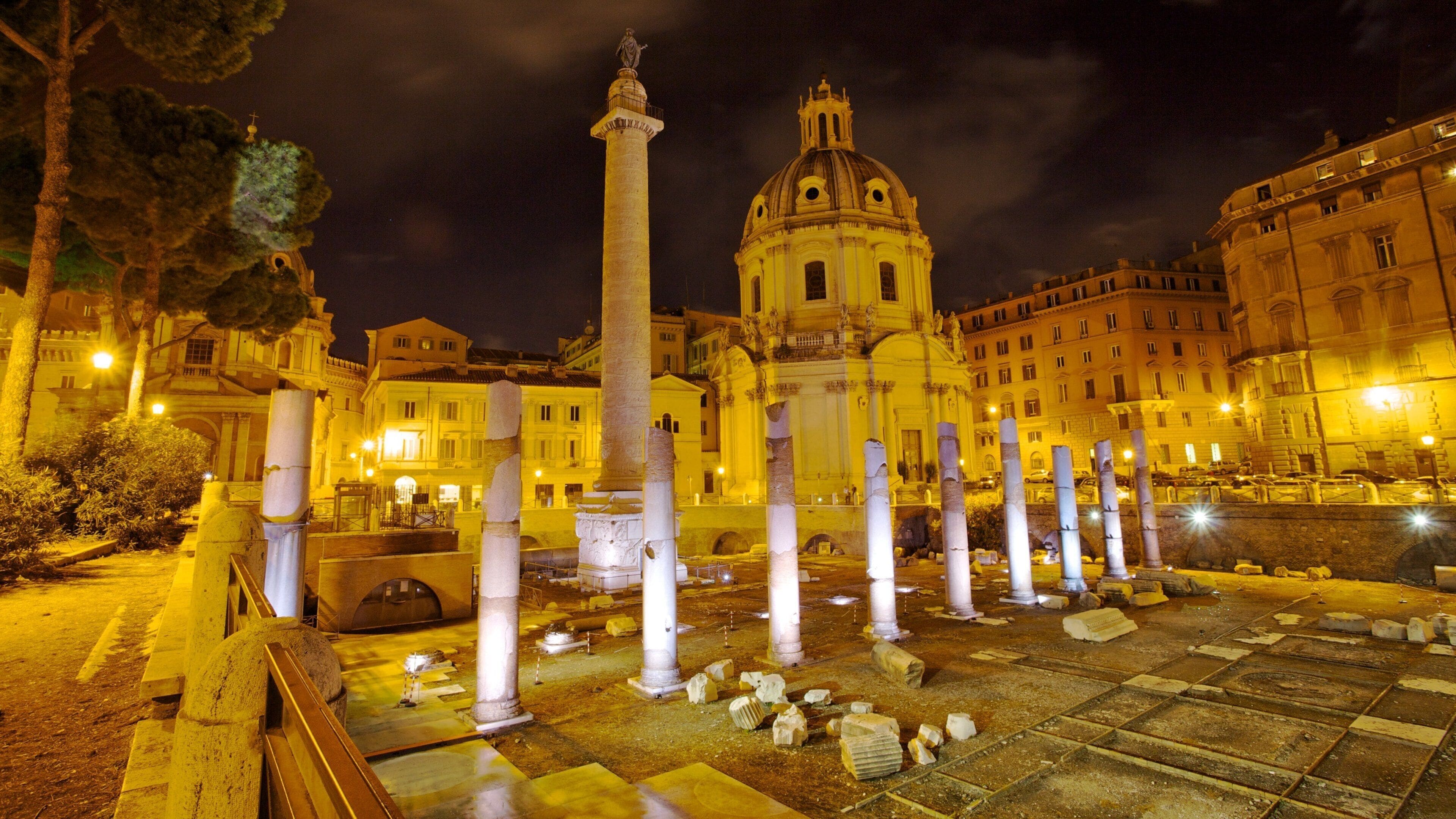 Exploring the illuminated ruins of the Roman Forum at night in Rome, Lazio, Italy