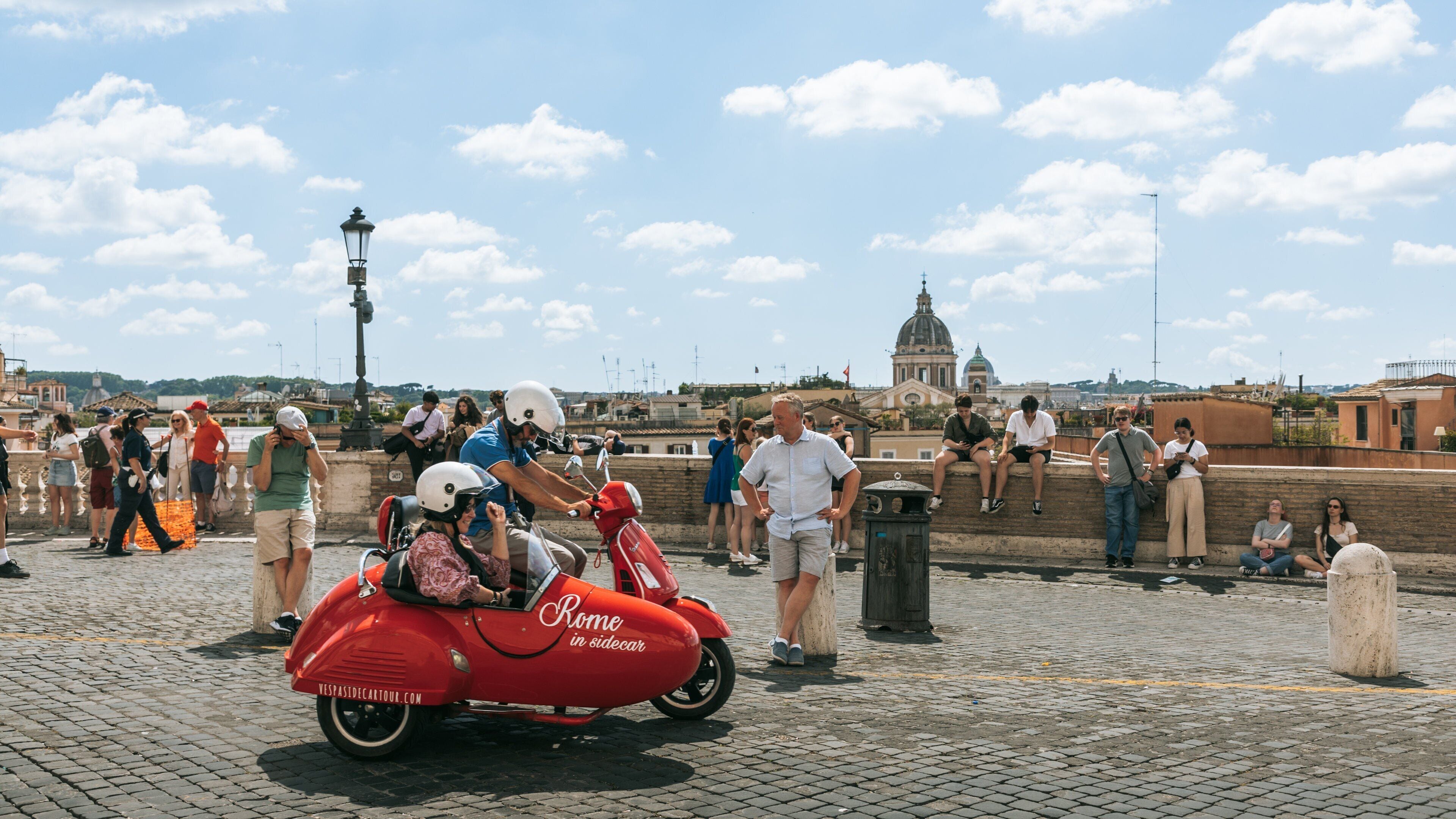 Piazza di Spagna showing street scenes and motorbike riding as well as a couple