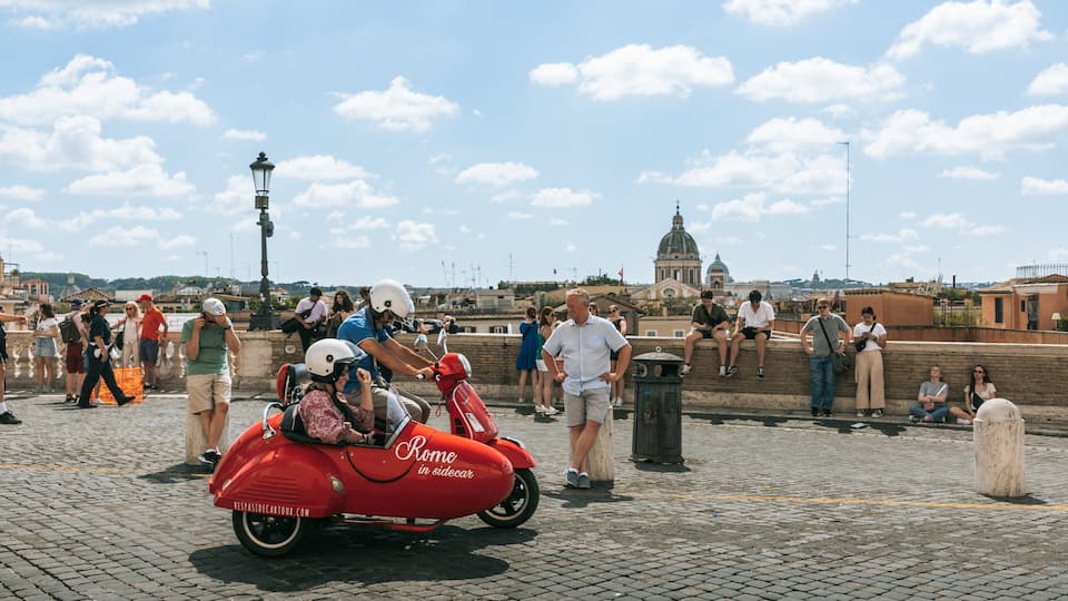 Piazza di Spagna showing street scenes and motorbike riding as well as a couple