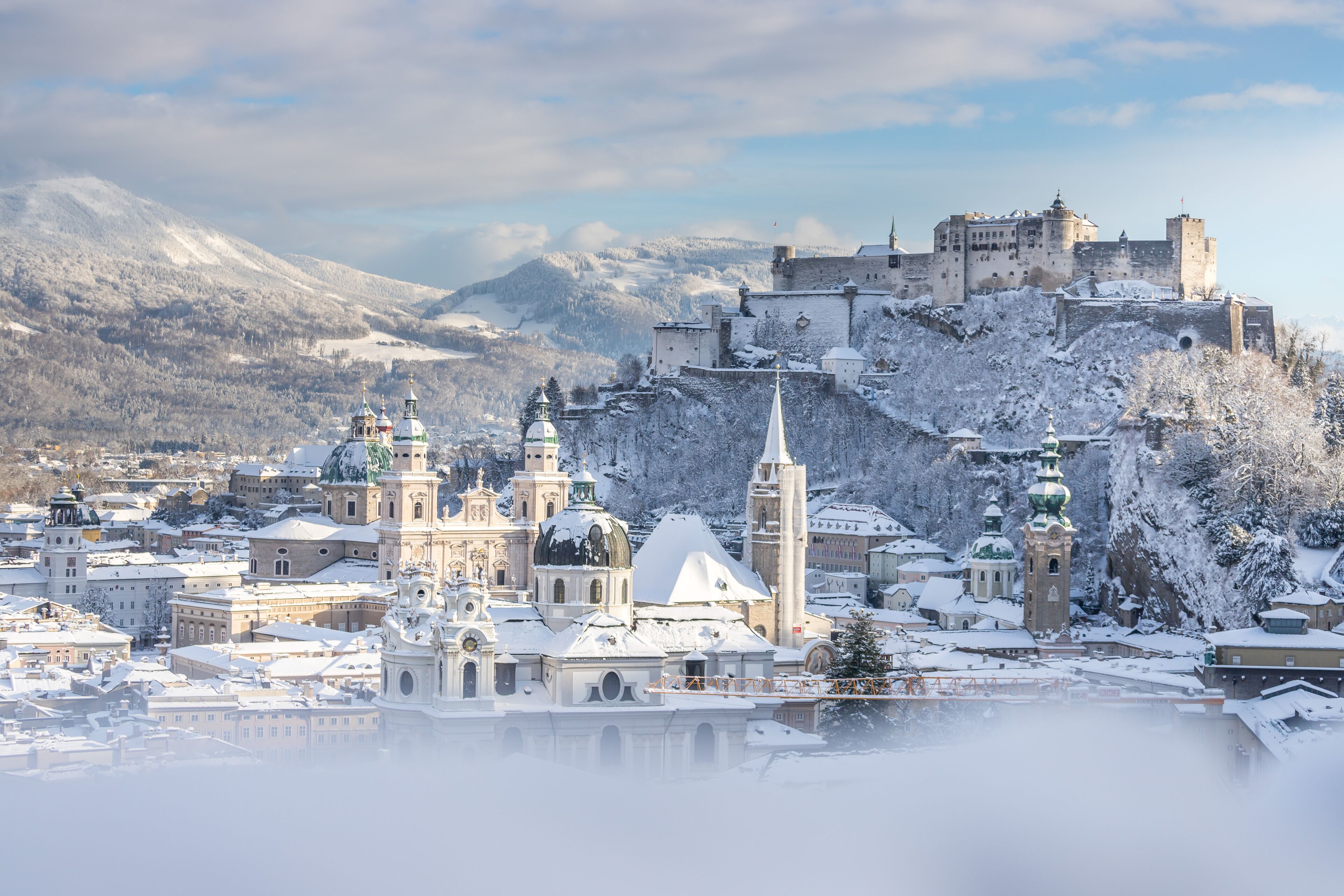 Panorama of Salzburg in winter: Snowy historical center, sunshine