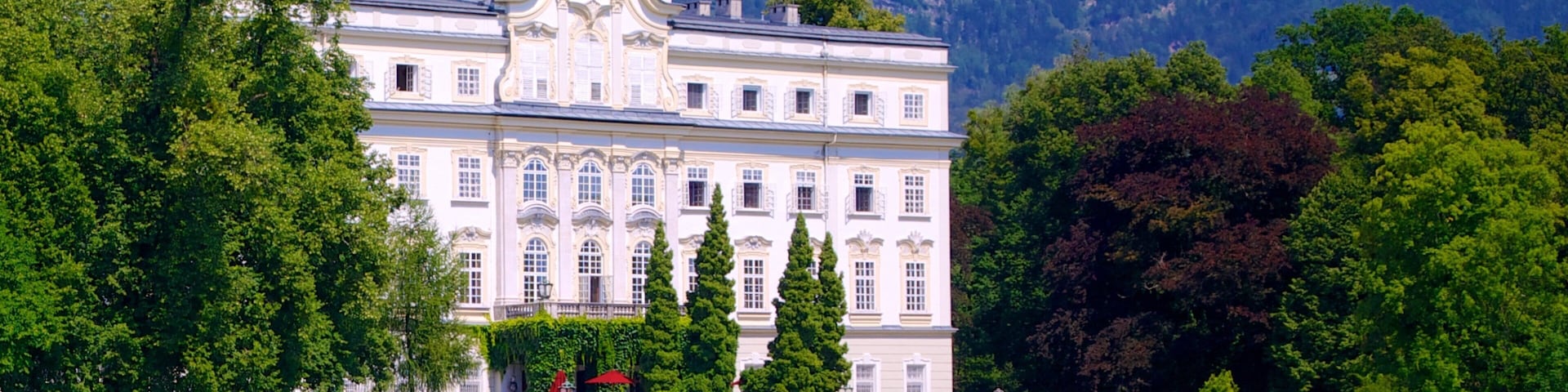 Leopoldskron Palace which includes heritage architecture, a castle and a lake or waterhole