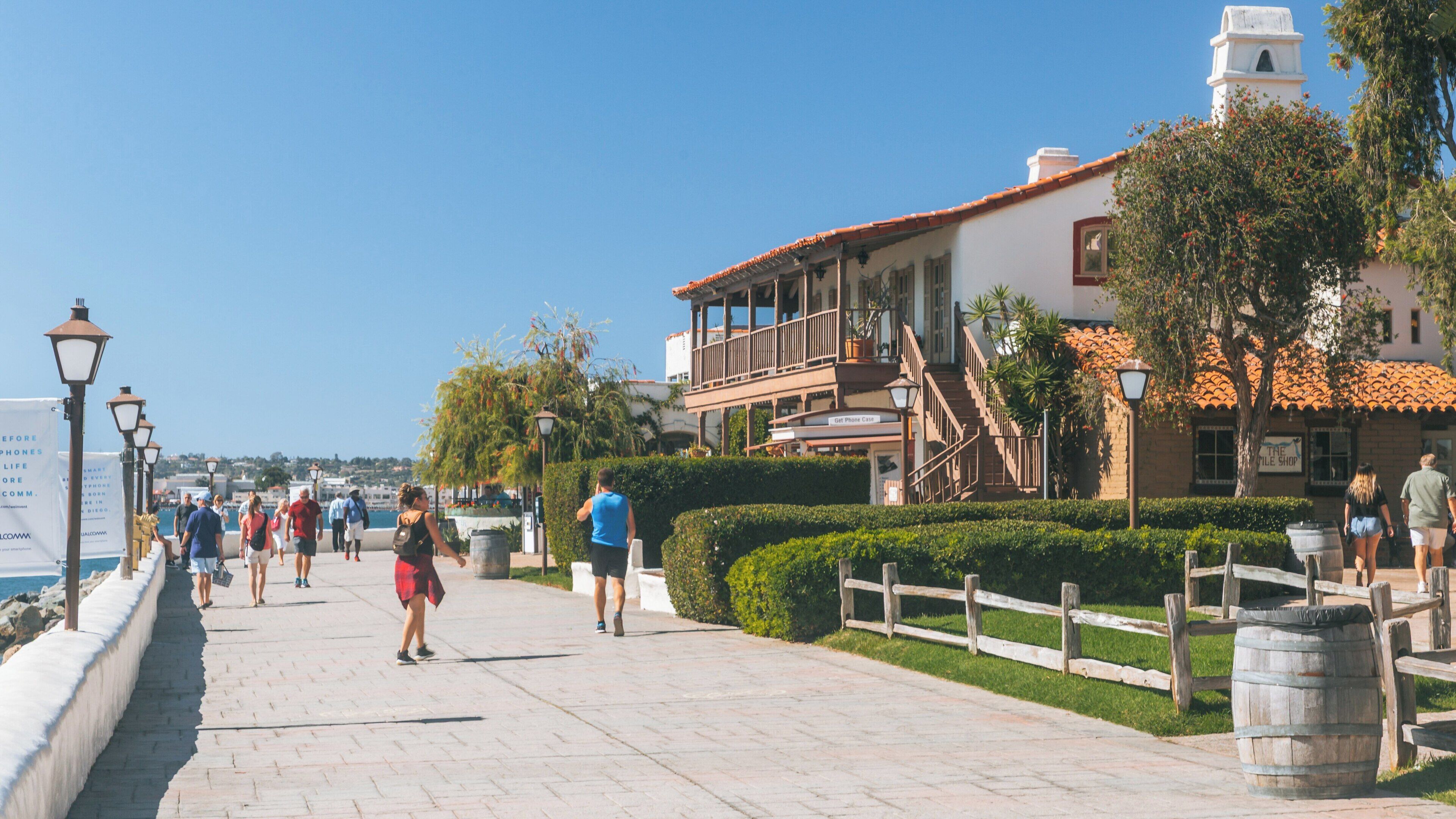 Strolling along the waterfront pathway of Seaport Village in Downtown San Diego, California on a sunny day