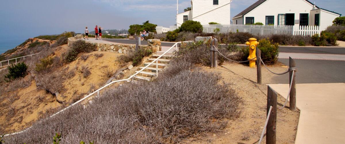 Cabrillo National Monument featuring a monument, a lighthouse and landscape views