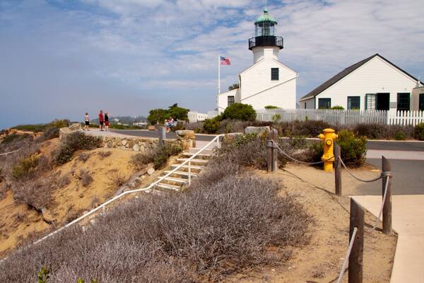 Cabrillo National Monument featuring a monument, a lighthouse and landscape views