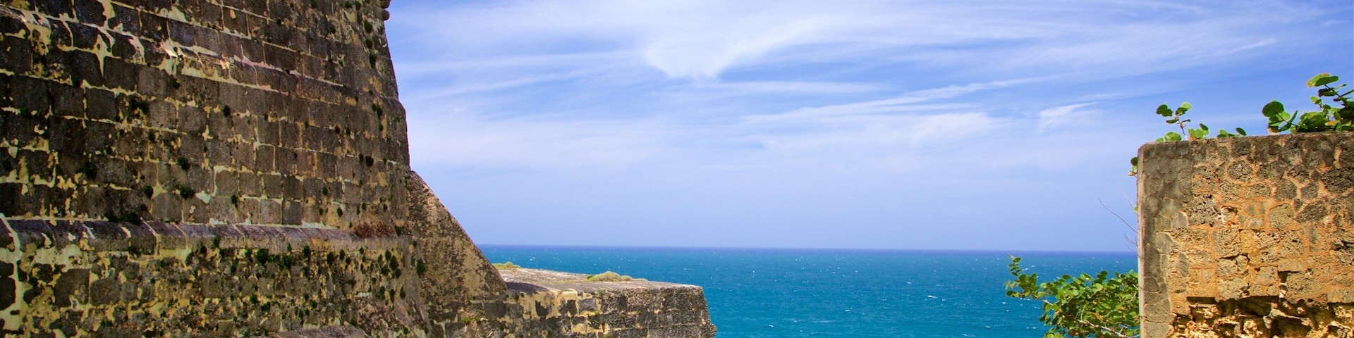 A coastal fort with a tower overlooking the sea.