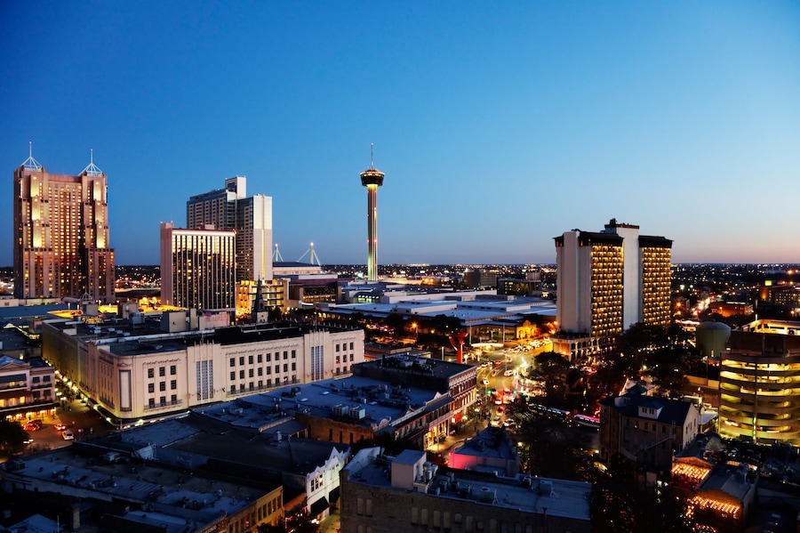 A cityscape with a prominent tower, several high-rise buildings, and a mix of commercial and residential structures.