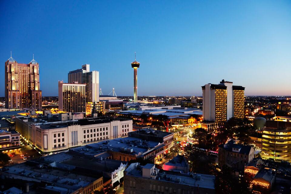 A cityscape with a prominent tower, several high-rise buildings, and a mix of commercial and residential structures.