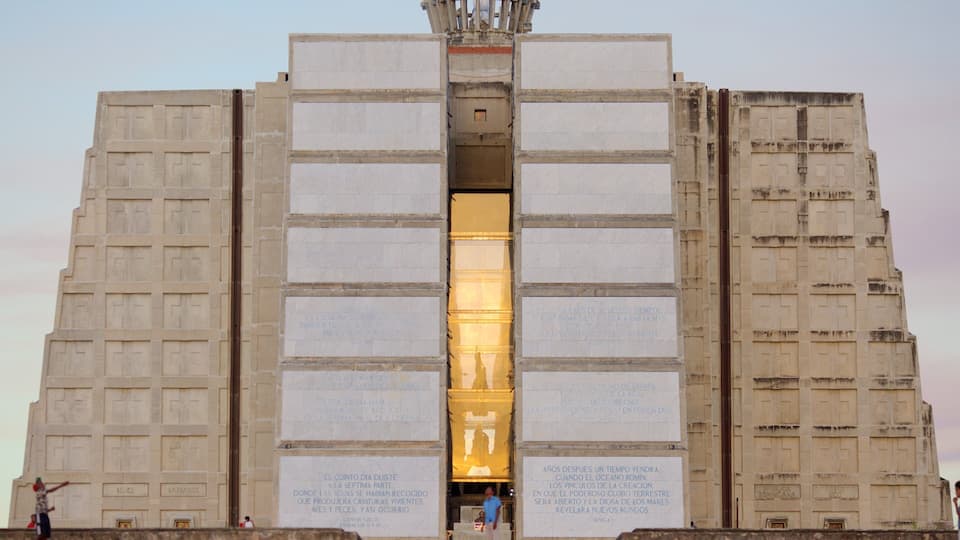 A large, symmetrical building with inscriptions and a central illuminated area.