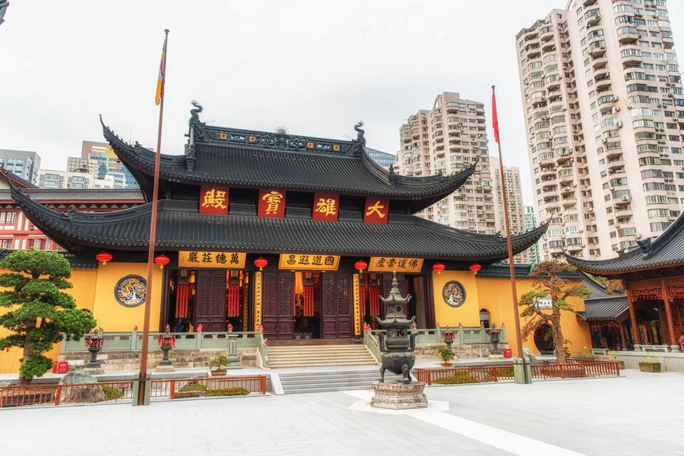 A traditional Chinese temple with ornate architecture, including a multi-tiered roof and red lanterns.