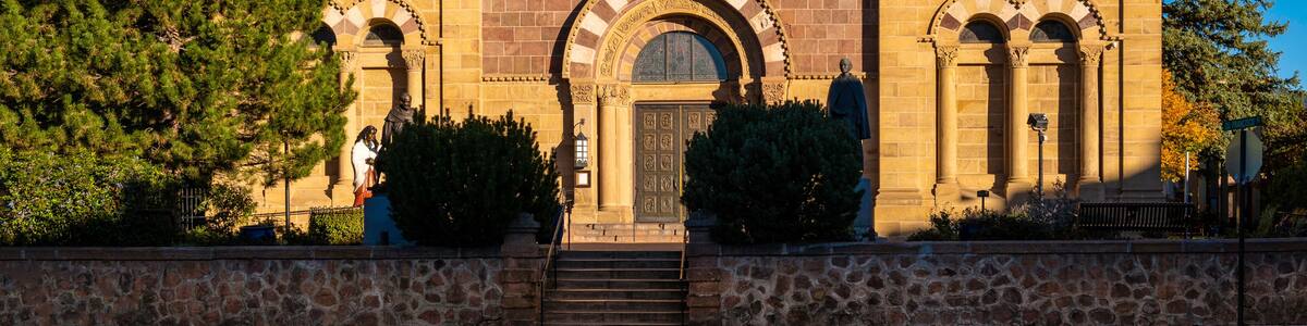 The facade of Cathedral Basilica of St. Francis of Assisi illuminated by the sun rays in Santa Fe, the capital of New Mexico