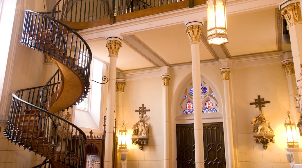 Loretto Chapel which includes a church or cathedral, religious elements and interior views
