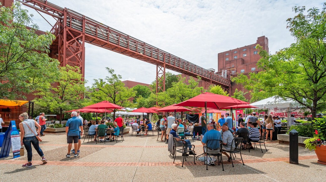 Anheuser-Busch Brewery which includes outdoor eating and a square or plaza as well as a small group of people