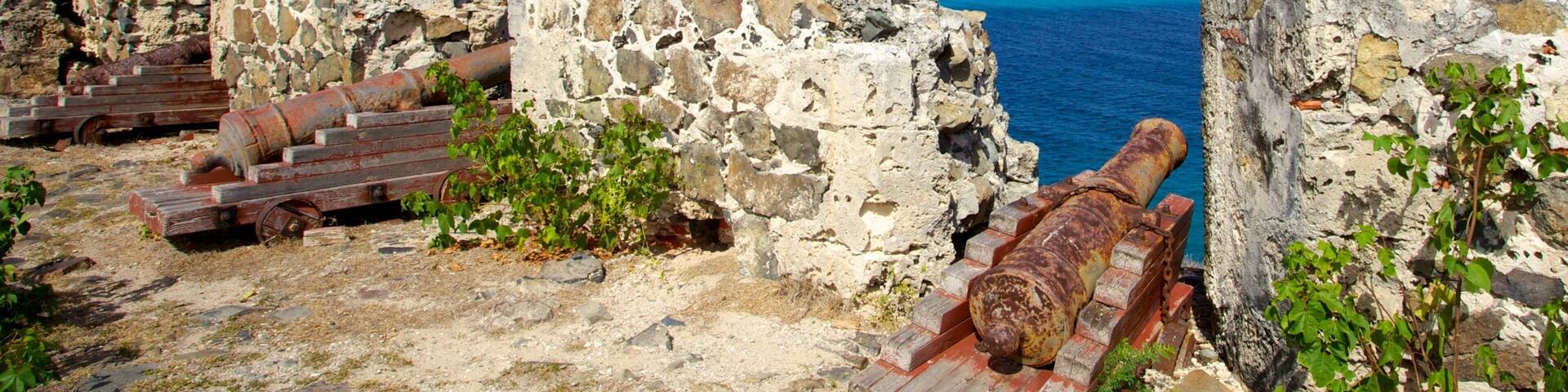 Fort Amsterdam which includes mountains, military items and general coastal views