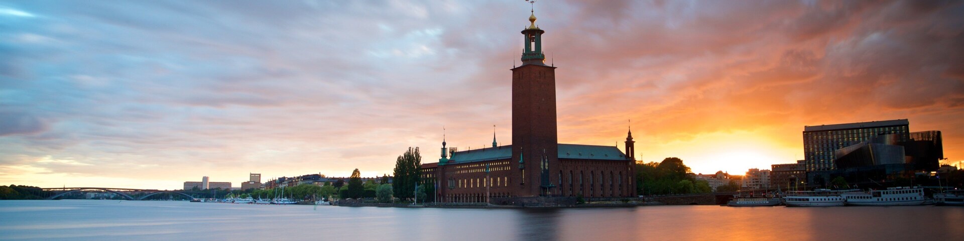 Stockholm City Hall showing a bay or harbor, a sunset and landscape views