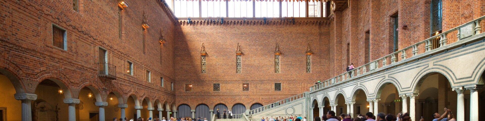 Stockholm City Hall which includes heritage elements and interior views as well as a small group of people